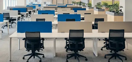 Modern open-plan office space featuring clean workstations, ergonomic chairs, and sanitized carpets provided by professional office cleaning services in Anchorage, AK.
